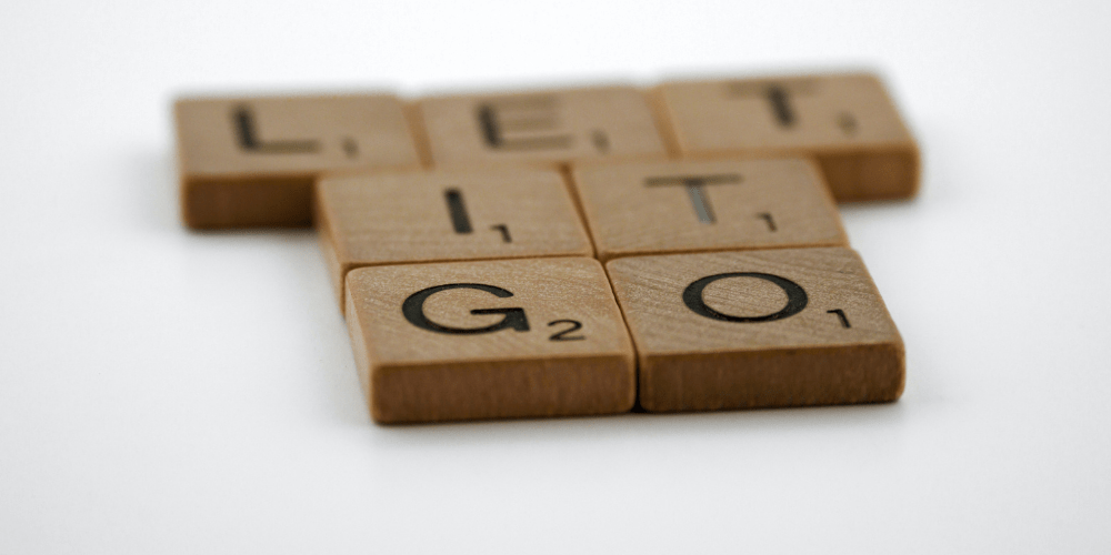 Scrabble tiles spelling the words, "let it go."