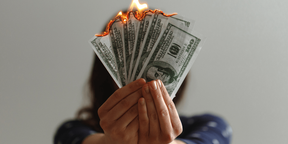 A woman burning money.