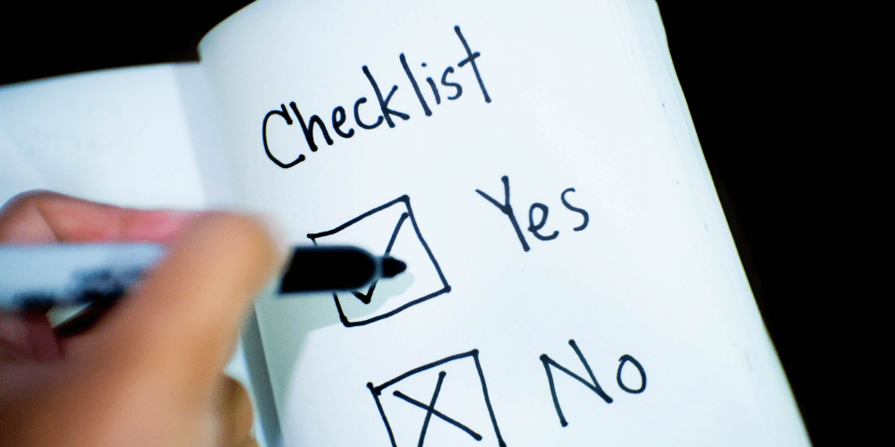 A paper with a checklist of "yes" and "no" for outsourcing examples