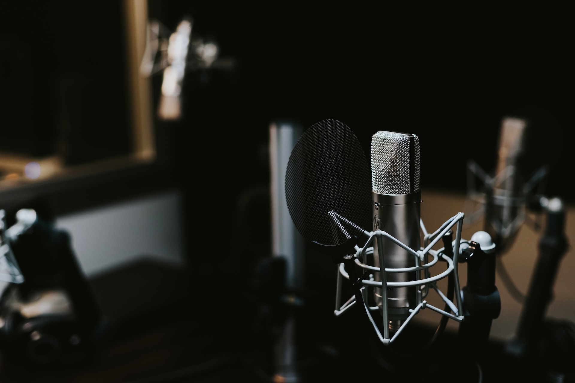 A recording studio grade microphone on a desk.