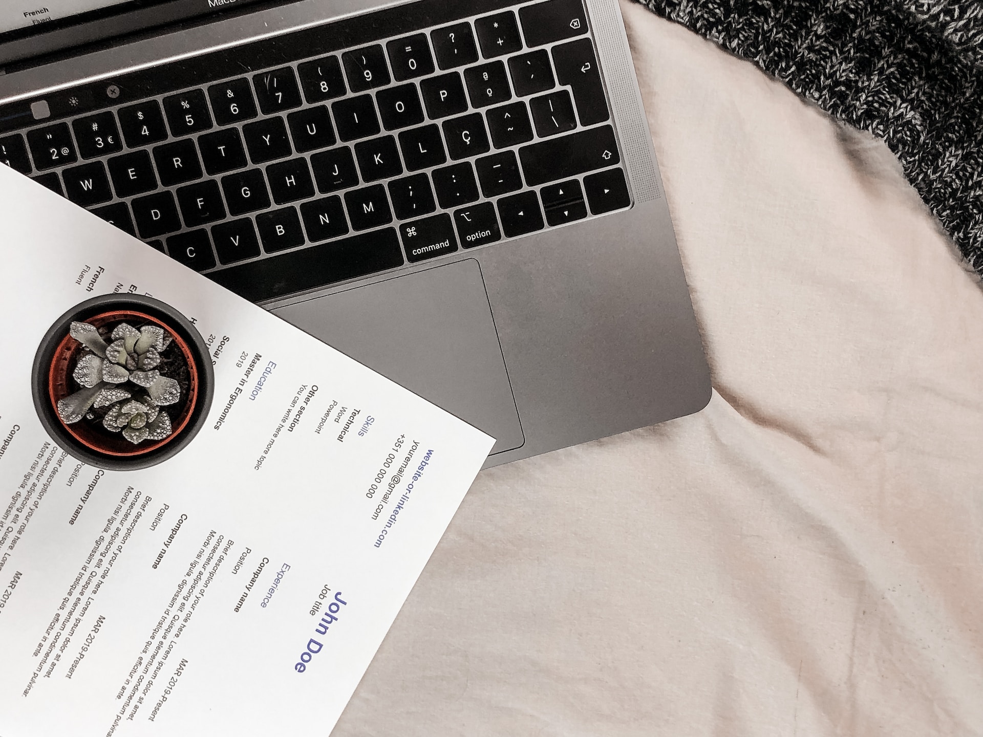 A virtual assistant resume examples next to a laptop.